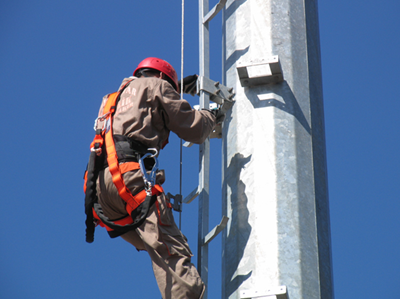 Engineer climbing a mono pole